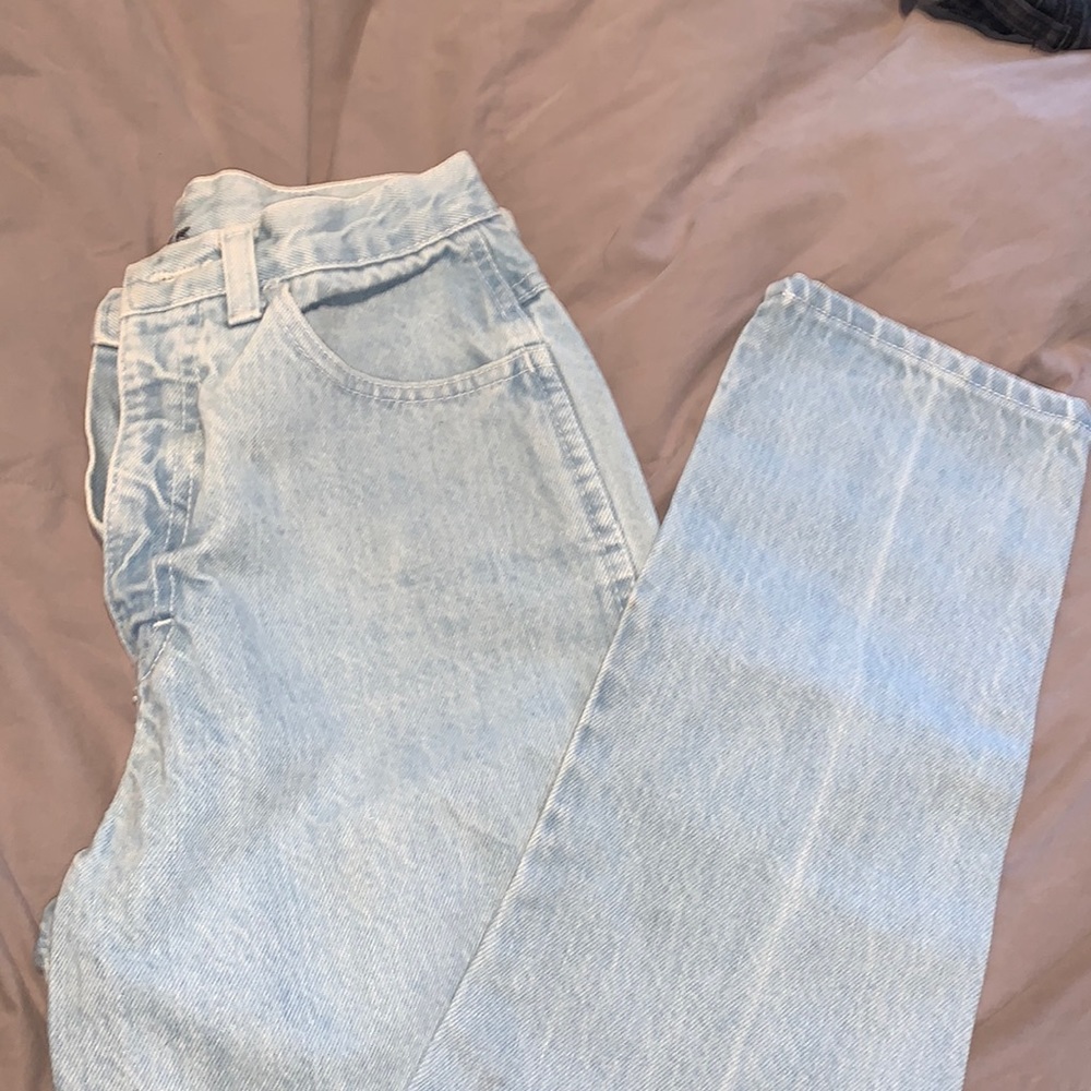 No brand jeans, light blue with triangle decor on back pocket.